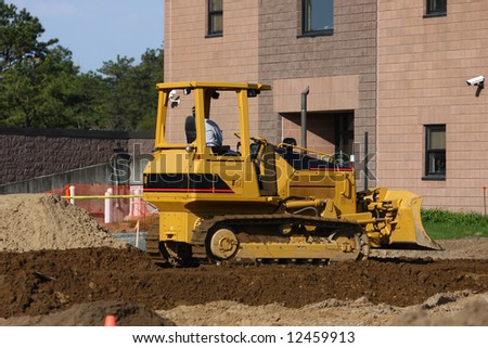Construction Equipment moving Soil at Building Site