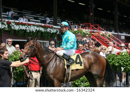 SARATOGA SPRINGS - August 18: Eibar Coa Aboard Tall Poppi Leads in the Winners Circle after the Second Race August 18, 2008 in Saratoga Springs, NY.