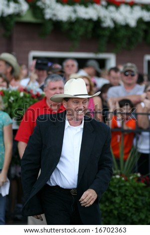 SARATOGA SPRINGS - August 16: Proud Spell Trainer Larry Jones Leaves the Winners Circle to Congratulate his horse and Jockey Following Alabama Stakes August 16, 2008 in Saratoga Springs, NY.
