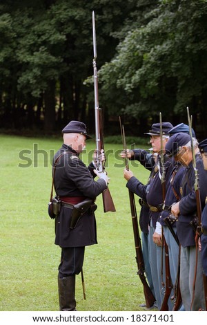 MENANDS - September 13: Union Officer Inspecting Rifle During a Civil War Reenactment at the Albany Rural Cemetery on September 13, 2008 in Menands, NY.