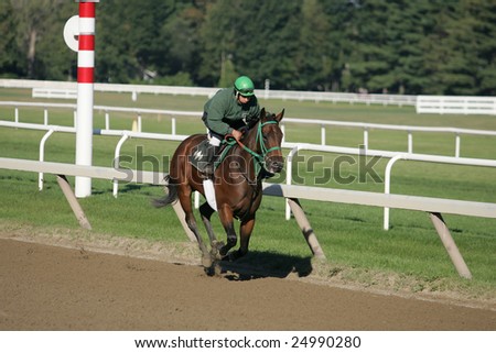 SARATOGA SPRINGS - October 1: Contessa Racing Rider Works a Thoroughbred on the Oklahoma Training Track on October 1, 2005 in Saratoga Springs, NY.
