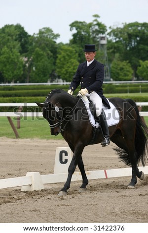 SARATOGA SPRINGS - MAY 23: Harry Diel competes on Carry On F. Gamdaard in Adult Amateur Division at the Dressage May 23, 2009 in Saratoga Springs, NY.