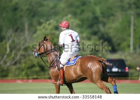 SARATOGA SPRINGS - JULY 10: Robert Kohen rides down the field in the opening match of the season at Saratoga Polo Club July 10, 2009 in Saratoga Springs, NY.