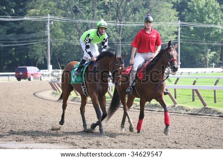 SARATOGA SPRINGS, NY- AUGUST 1:  Julien Leparoux (L) aboard Wicked Rich in the post parade for the 7th race at Saratoga Race Track August 1, 2009 in Saratoga Springs, NY.
