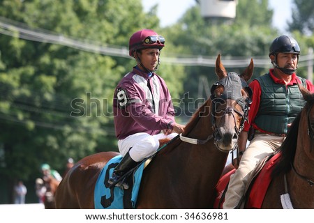 SARATOGA SPRINGS, NY- AUGUST 1:  Rajiv Maragh aboard C Street with pony boy on the inside during the post parade for the 7th race at Saratoga Race Track - August 1, 2009 in Saratoga Springs, NY.