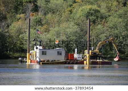 FORT EDWARD, NY- SEPT 26: Dredging Crane dumps clean fill to cover up sediment during PCB cleanup in the Hudson River, SEPT 26, 2009 in Fort Edward, NY.