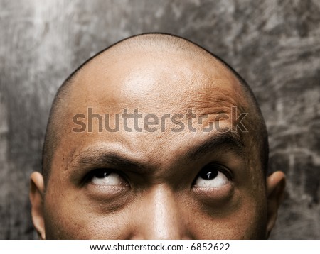 bald headed man with confuse expression