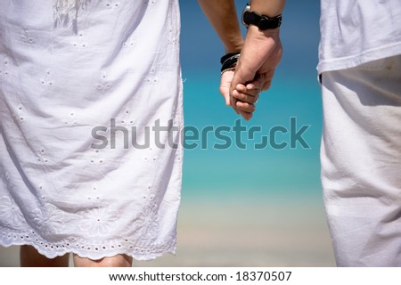 lovers holding hands on beach. holding hands on the each