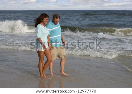 A couple walking together on the Alabama gulf coast.