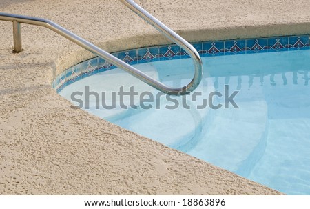 A swimming pool with a cement deck.