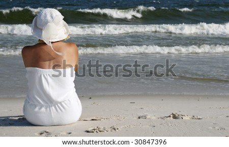 A woman sitting on the Alabama gulf coast.