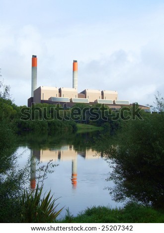 Factory with smoke stack by the river