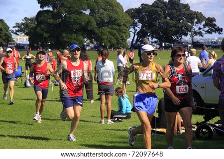 AUCKLAND- Feb. 27: Participants in the Cathay Pacific  Auckland marathon run sprint to the finish line on Sunday Feb. 27,2011 at  Orakei, Auckland, New Zealand