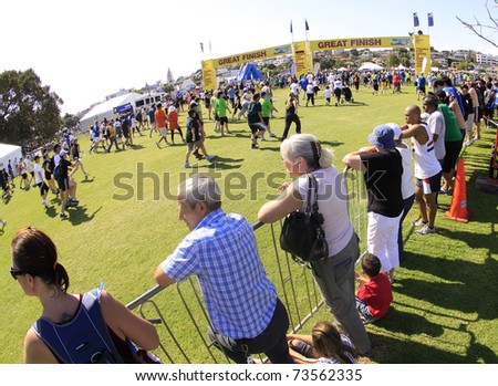 AUCKLAND - MARCH 13: Spectators and participants of Auckland Round the Bays fun walk and run with an estimated 70,000 entrants, in Auckland, New Zealand on Sunday March 13, 2011 at the finish line