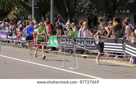 AUCKLAND- OCT. 30: Unidentified participants in the Adidas Auckland marathon run sprint to the finish line on Sunday Oct. 30,2011 in  Auckland, New Zealand