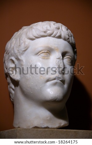 Roman statue of Caesar on dark red background