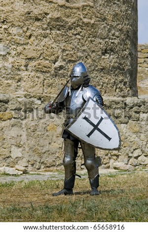Medieval european knight near citadel wall