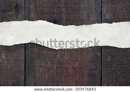 recycled paper ripped on real wood background
