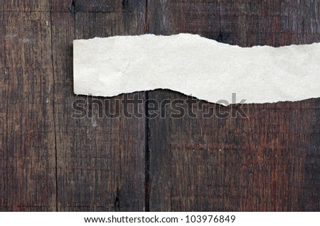 recycled paper ripped on real wood background