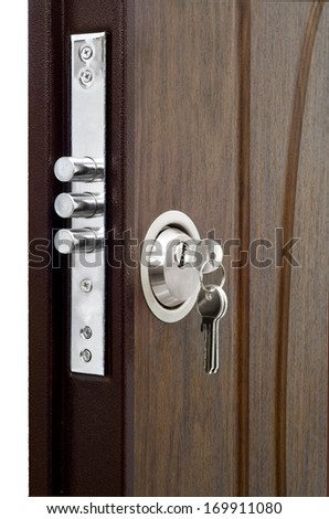 Unlocking a house door with a key on a keyring