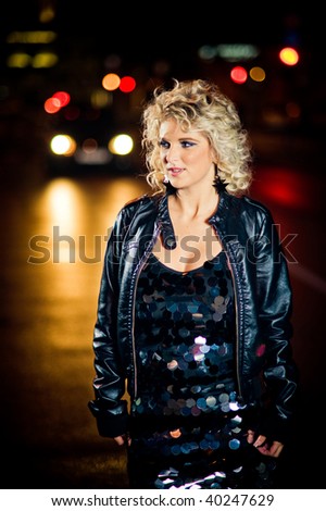 Attractive blond girl on the late night street