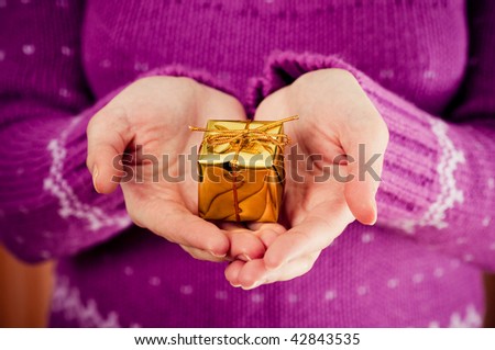 Small wrapped gift in hands