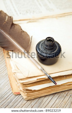 Old book, quill and black ink