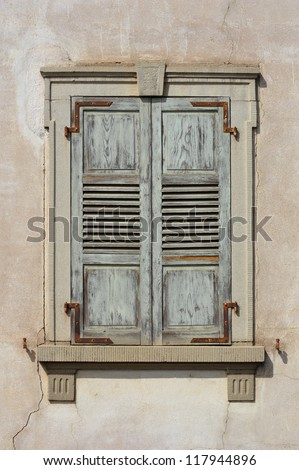 Wooden window shutters - Closed old shuttered weathered wooden window in the Alsace, France