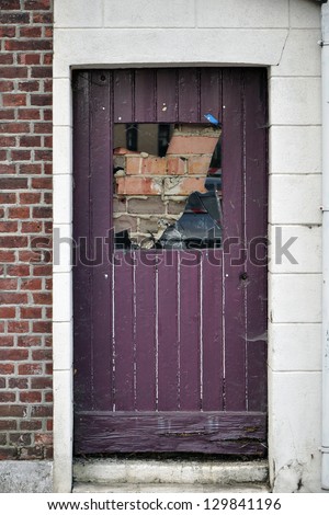 Bricked Door - Closed grunge door with behind the door a brick wall
