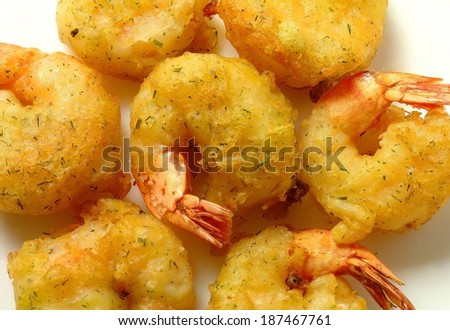 fried fish and shrimp in sunflower oil, white background. art of cooking,
