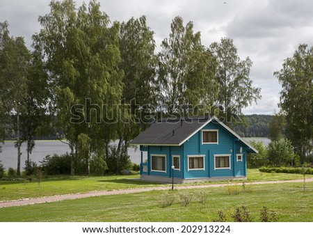 Wooden house in the forest near the lake. gated community on the shore