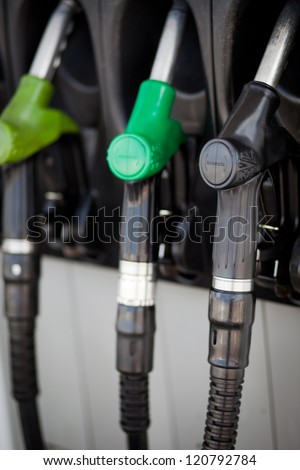 Detail of hoses of petrol pump at a gas station, selective focus