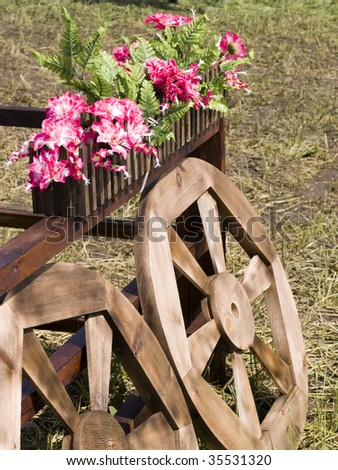 Village landscape with wooden wheels from an ancient cart