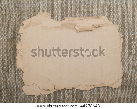 very old yellowed paper on an old cloth background