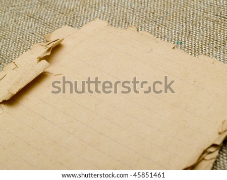 very old yellowed paper on an old cloth background