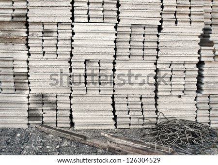 Pallet of new concrete blocks vertically stacked together, black and white background texture