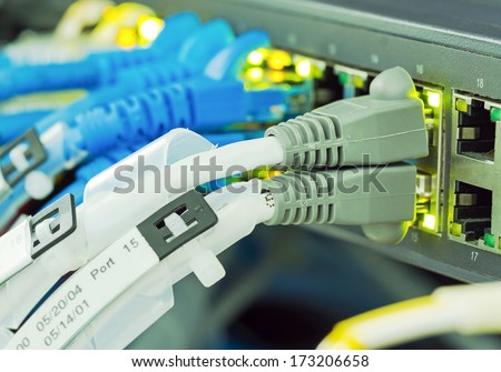 Ethernet cables with grey connector plug in to equipment