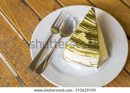 Delicious of Green tea crepe cake on wooden table, top view