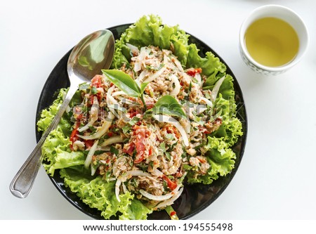 Salad of tuna fish with fresh green tea leaves, Iceberg lettuce, tomato and chili isolated on white background