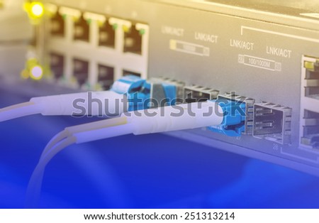 Optical single mode LC patch cord with blue connector plug in to equipment in data center - Color filter style pictures