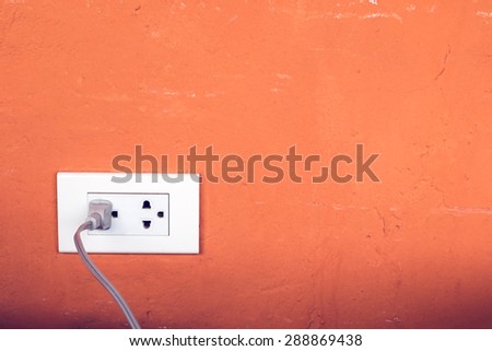 Close up of power plug plugged in a wall socket