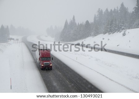 Dangerous driving on snow-covered interstate highway in winter