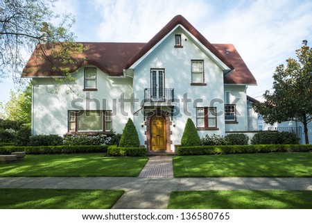 White American craftsman stucco house with a red roof