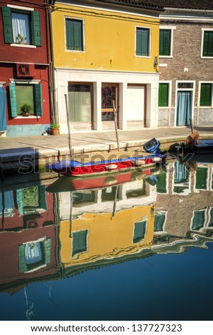 Multi-colored houses and their reflections in a canal, Burano, Italy