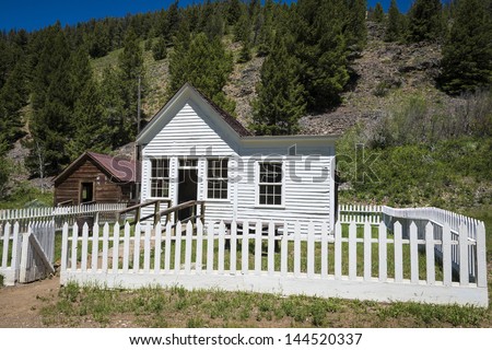 Old house with white picket fence in ghost town of Custer, Idaho