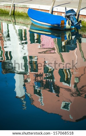 Blurred reflections of houses in a canal, Burano, Italy