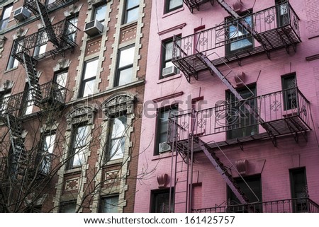 Pink apartment building with fire escapes, New York City