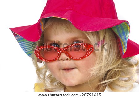 Blond baby girl in red hat and sunglasses