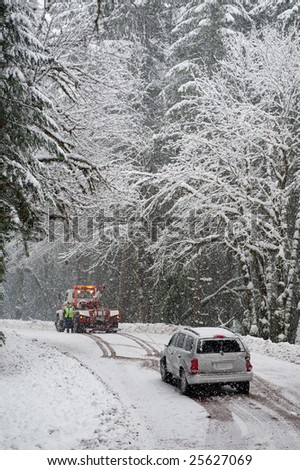 Car being towed after accident in snow storm