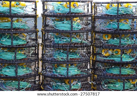 Stack of crab traps and colorful buoys.